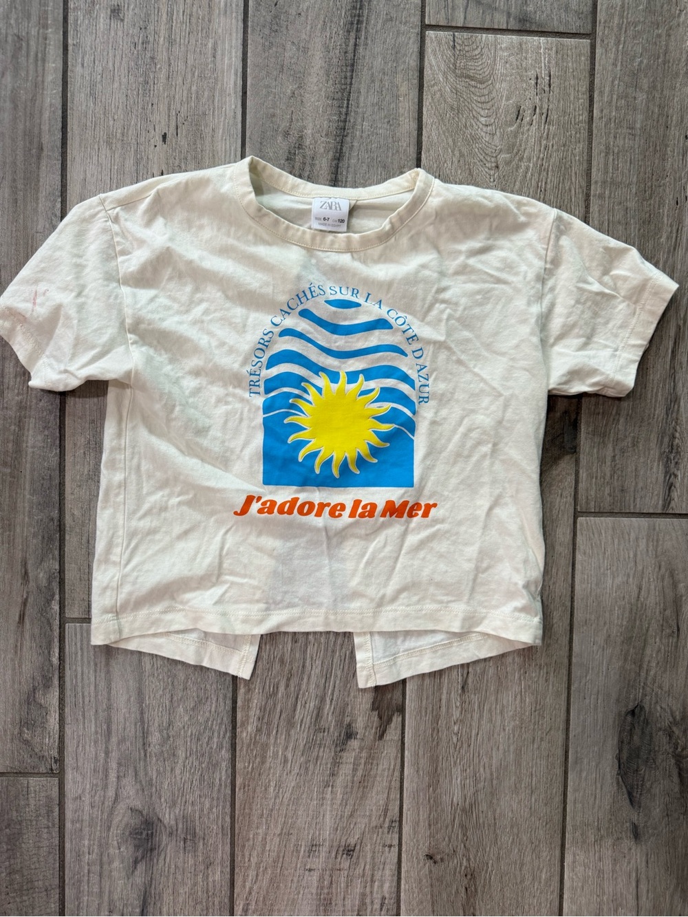 ZARA Cream Tee with Blue Waves, Yellow Sun & Orange Text